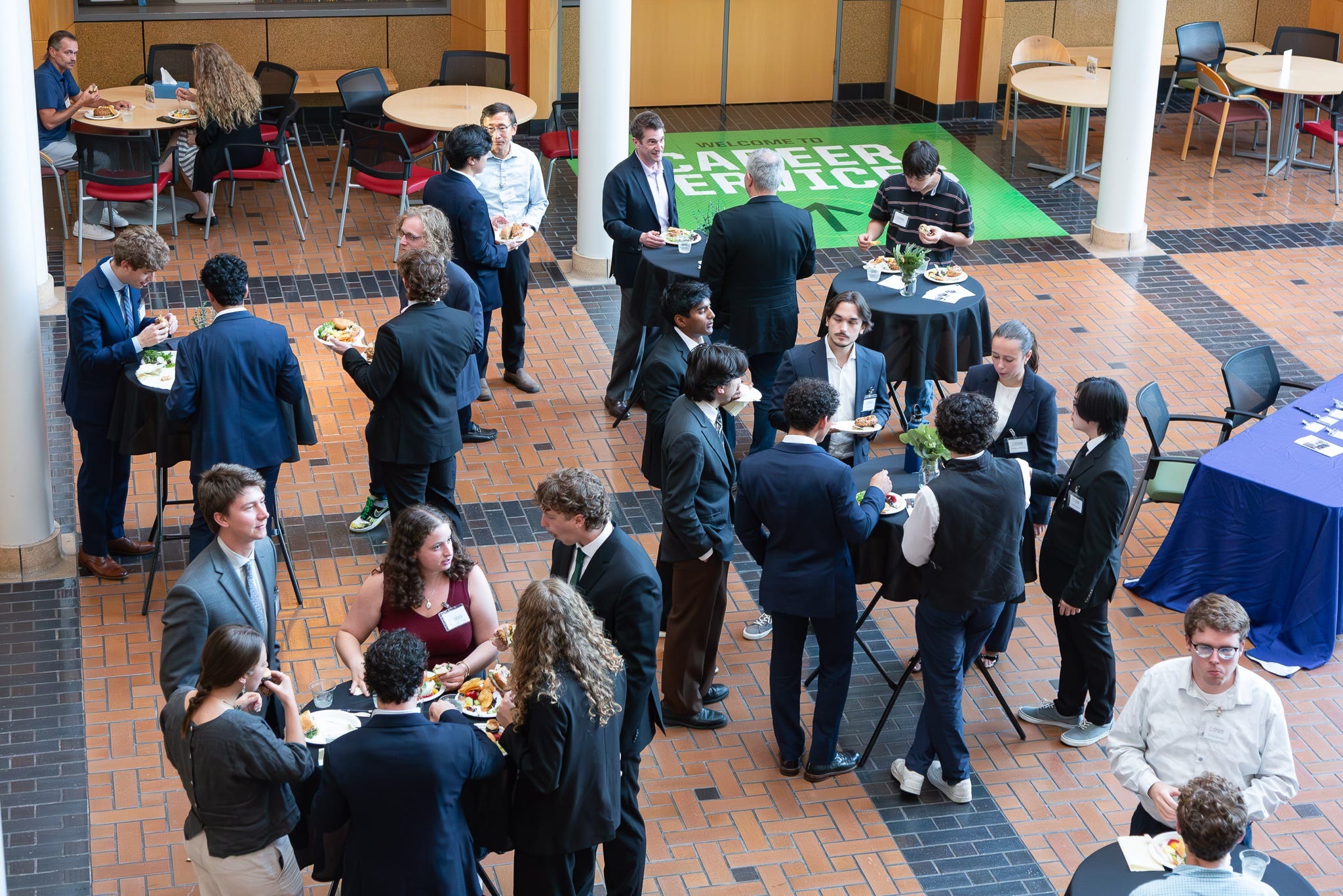 Members and industry guests mixing at cocktail tables during the OQG networking lunch