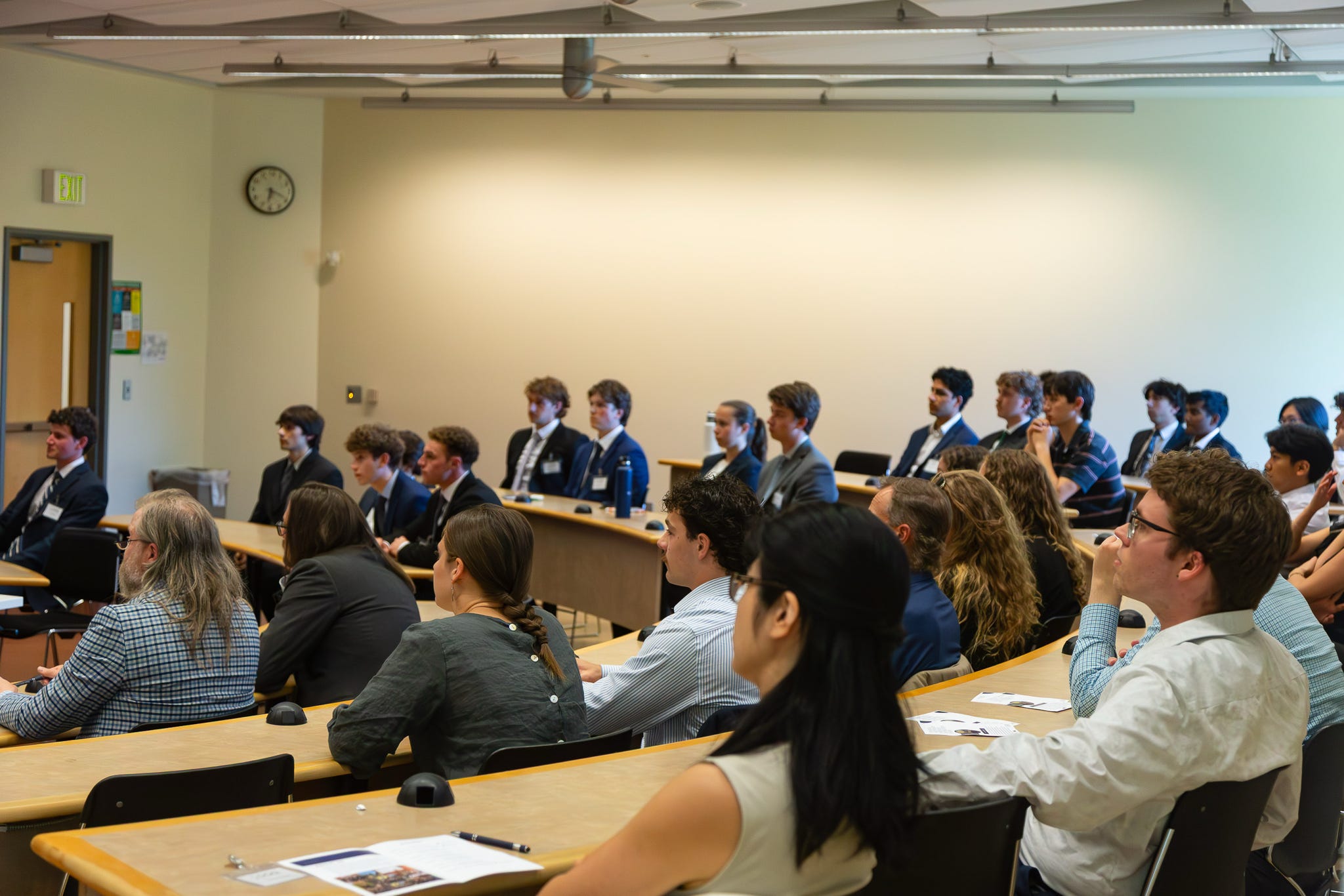 Members and industry guests filling a lecture hall for the OQG showcase